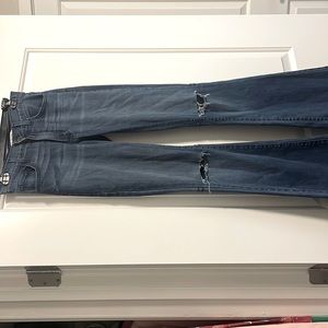 O2 Denim bell bottom flares with slit knees.